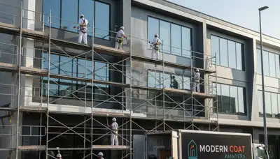 Professional commercial painters in Nashville, TN applying durable coatings to business exterior