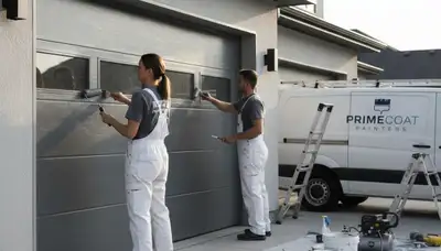 Professional painters refinishing a garage door in Nashville, TN for enhanced curb appeal and durability