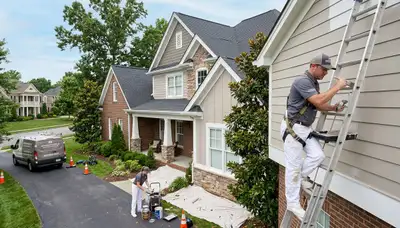 Professional house painters improving home exterior in Nashville, TN